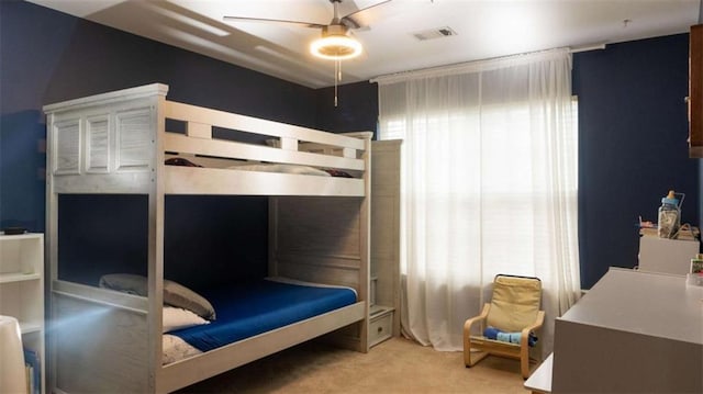 bedroom featuring ceiling fan and light colored carpet