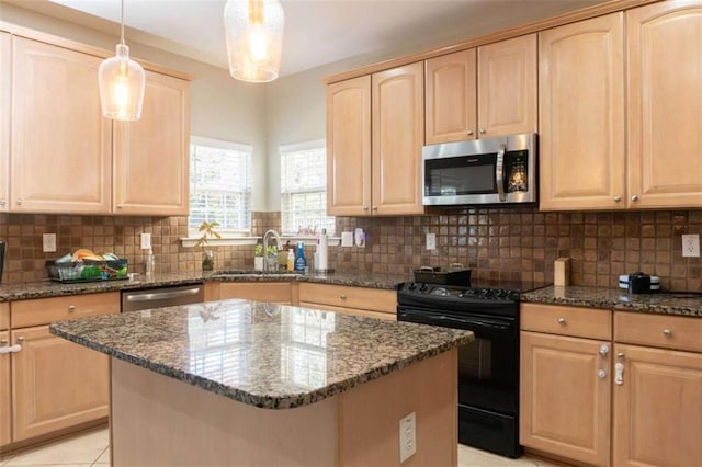 kitchen featuring pendant lighting, dark stone countertops, backsplash, and appliances with stainless steel finishes