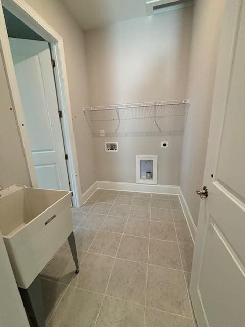 laundry room featuring electric dryer hookup, hookup for a washing machine, and light tile patterned floors