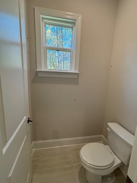 bathroom with tile patterned flooring and toilet