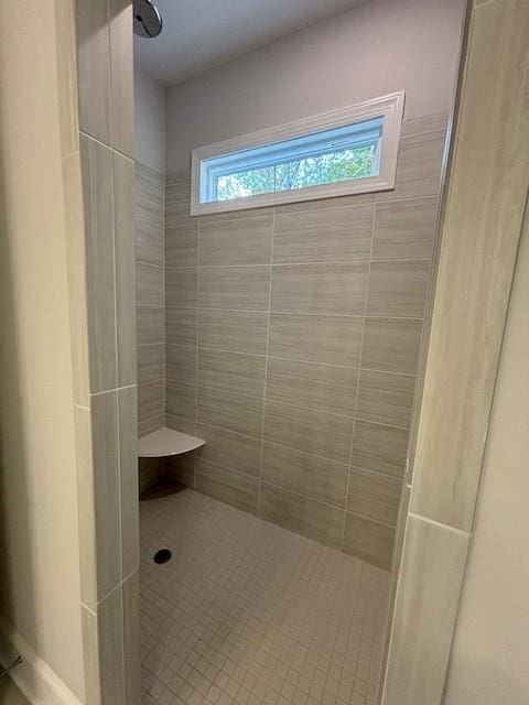 bathroom with a tile shower