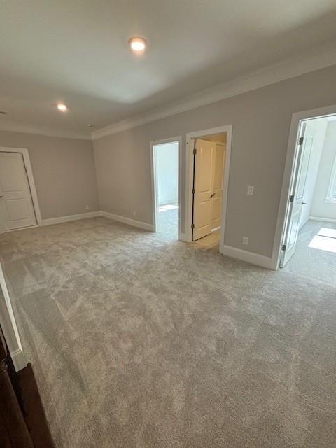 carpeted empty room with crown molding