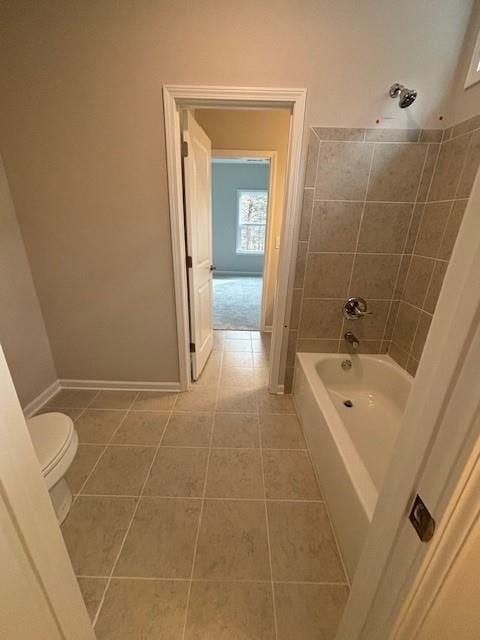 bathroom featuring tile patterned flooring, toilet, and shower / tub combination