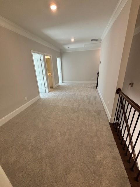 unfurnished room featuring dark carpet and ornamental molding