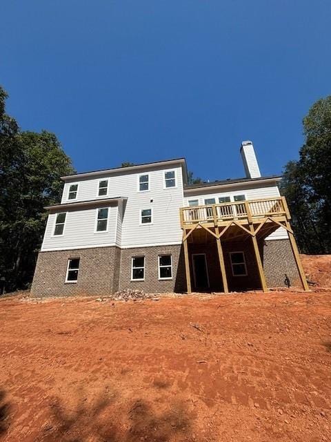 back of property with a wooden deck