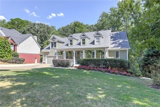 cape cod-style house with a garage, a front yard, and a porch