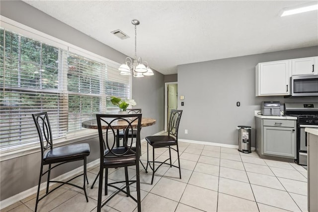 250 Kensington Trce, Stockbridge, GA 30281 - dining area with a chandelier, light tile patterned floors, and baseboards