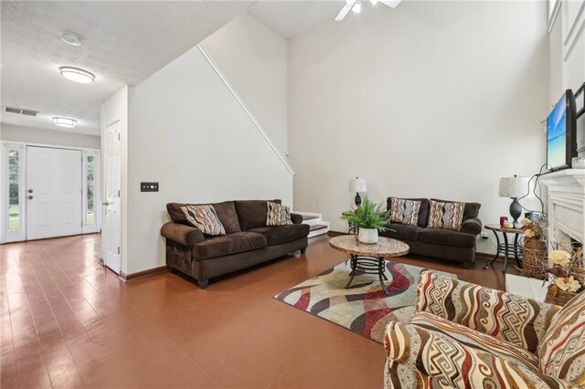 250 Kensington Trce, Stockbridge, GA 30281 - living room with a fireplace, baseboards, and a ceiling fan
