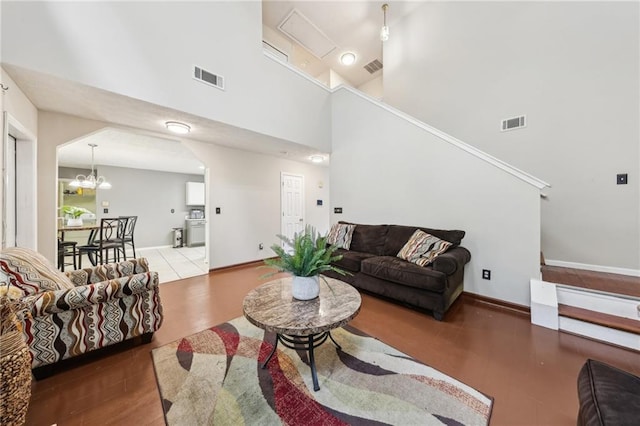 250 Kensington Trce, Stockbridge, GA 30281 - living area with a high ceiling, wood finished floors, baseboards, and a chandelier