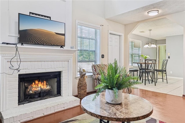 250 Kensington Trce, Stockbridge, GA 30281 - living area with a fireplace, a chandelier, and baseboards