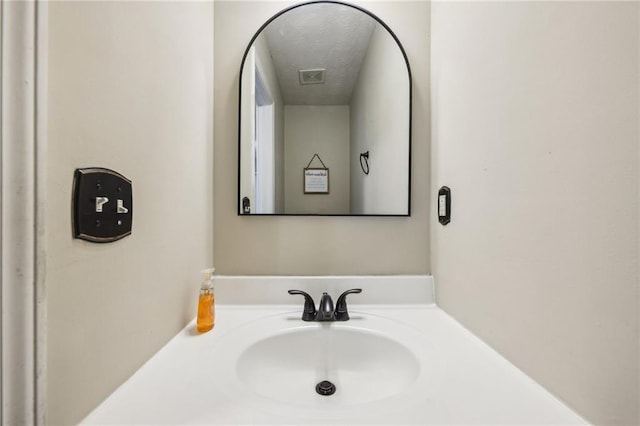 250 Kensington Trce, Stockbridge, GA 30281 - bathroom featuring a textured ceiling and vanity