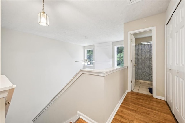 250 Kensington Trce, Stockbridge, GA 30281 - hall featuring an upstairs landing, attic access, wood finished floors, and baseboards