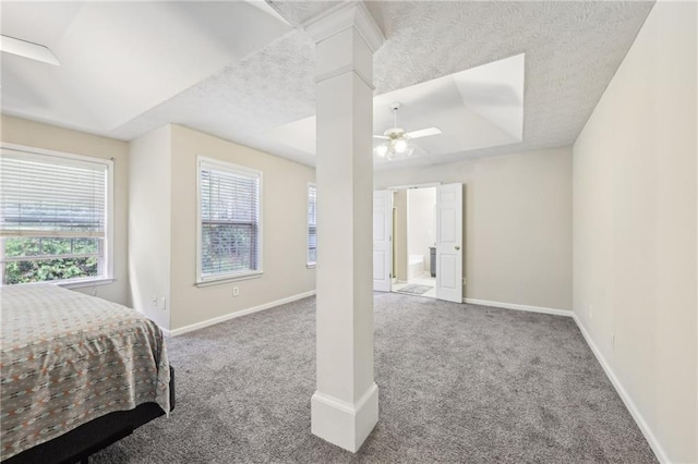250 Kensington Trce, Stockbridge, GA 30281 - carpeted bedroom featuring decorative columns, baseboards, ceiling fan, and a textured ceiling