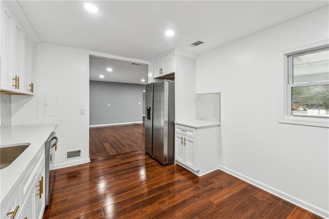 kitchen with white cabinets, light stone countertops, and appliances with stainless steel finishes