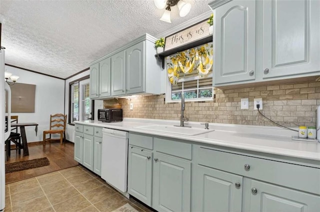 51 Ocoee Trl, Blue Ridge, GA 30513 - kitchen featuring dishwasher, a textured ceiling, light countertops, decorative backsplash, and crown molding