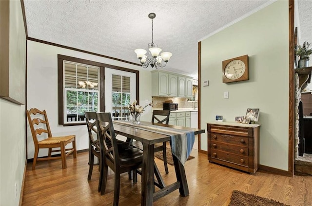 51 Ocoee Trl, Blue Ridge, GA 30513 - dining space featuring a chandelier, ornamental molding, a textured ceiling, and light wood-style floors