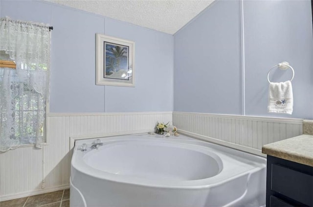 51 Ocoee Trl, Blue Ridge, GA 30513 - full bathroom featuring vanity, a bath, a textured ceiling, tile patterned flooring, and a wainscoted wall
