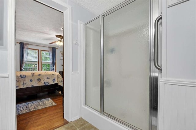 51 Ocoee Trl, Blue Ridge, GA 30513 - bathroom with ensuite bath, a stall shower, a textured ceiling, and a ceiling fan