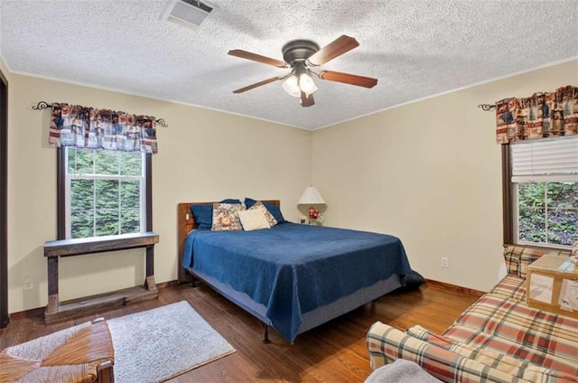 51 Ocoee Trl, Blue Ridge, GA 30513 - bedroom featuring multiple windows, a textured ceiling, wood finished floors, ceiling fan, and crown molding