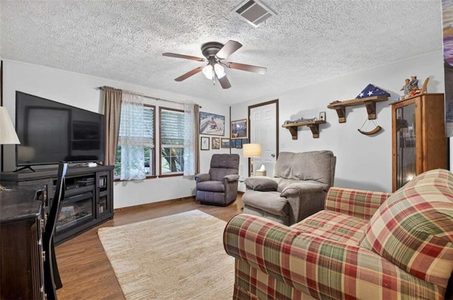 51 Ocoee Trl, Blue Ridge, GA 30513 - living room with wood finished floors, a ceiling fan, and a textured ceiling