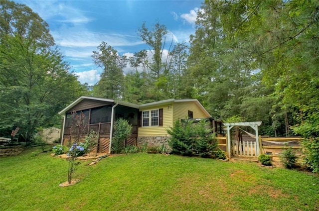 51 Ocoee Trl, Blue Ridge, GA 30513 - back of house featuring a sunroom and a lawn