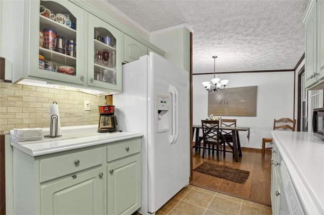51 Ocoee Trl, Blue Ridge, GA 30513 - kitchen with green cabinets, light countertops, a textured ceiling, white fridge with ice dispenser, and ornamental molding
