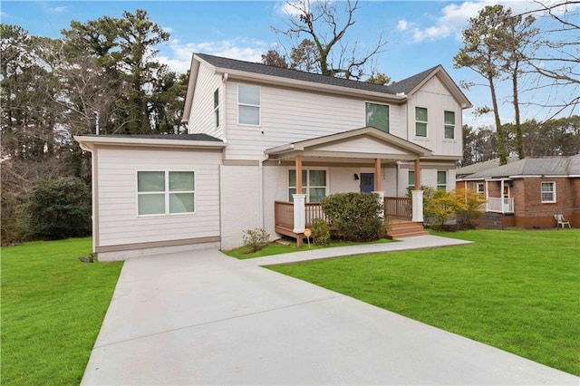 view of front of house featuring covered porch and a front lawn