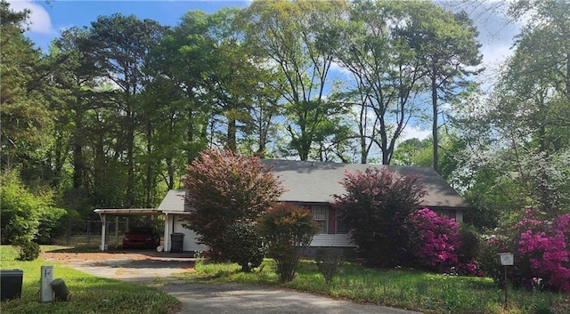 402 Emmett St, Riverdale, GA 30165 - view of property hidden behind natural elements with driveway and a carport