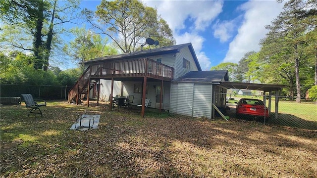 402 Emmett St, Riverdale, GA 30165 - back of property with stairs, a deck, an attached carport, and a storage unit