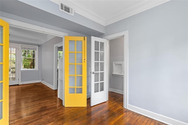 empty room featuring french doors, ornamental molding, baseboards, and visible vents