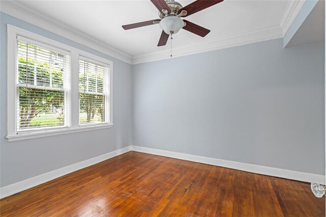 unfurnished room featuring baseboards, crown molding, and a wealth of natural light