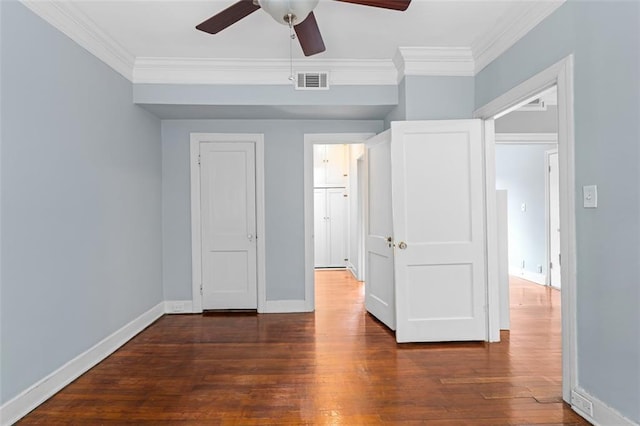 unfurnished bedroom featuring wood-type flooring, baseboards, visible vents, and ornamental molding
