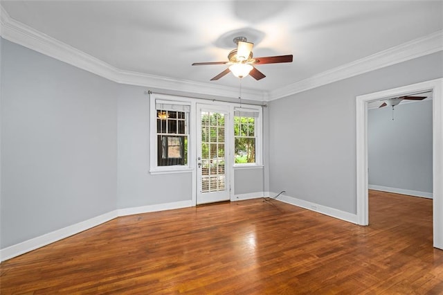 unfurnished room with baseboards, ornamental molding, ceiling fan, and wood finished floors
