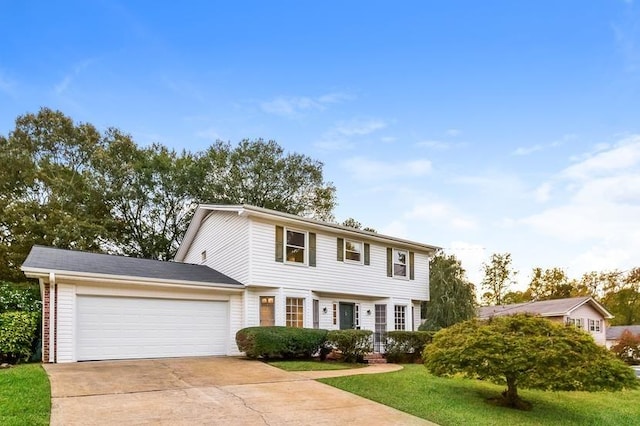 colonial house with a garage and a front lawn