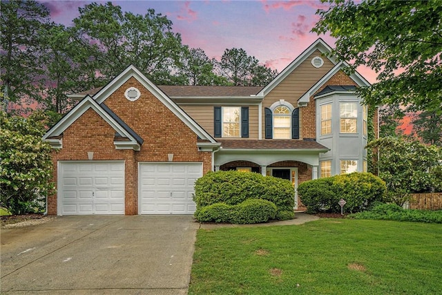 traditional-style home featuring concrete driveway, a front yard, and brick siding