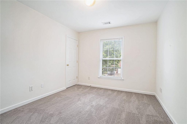 unfurnished room with carpet flooring and baseboards