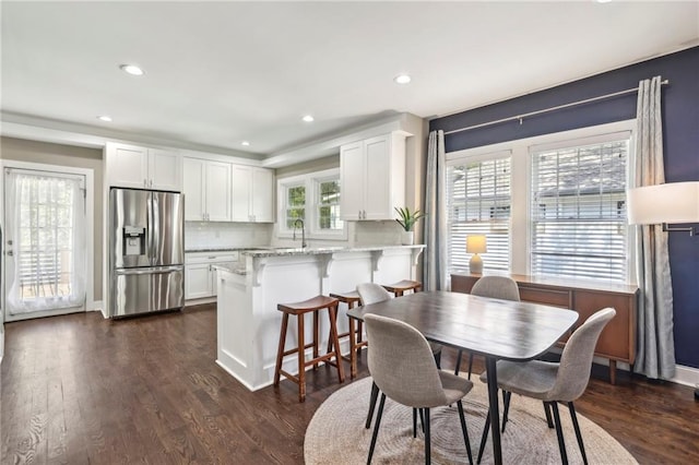 dining room with plenty of natural light and dark wood-type flooring