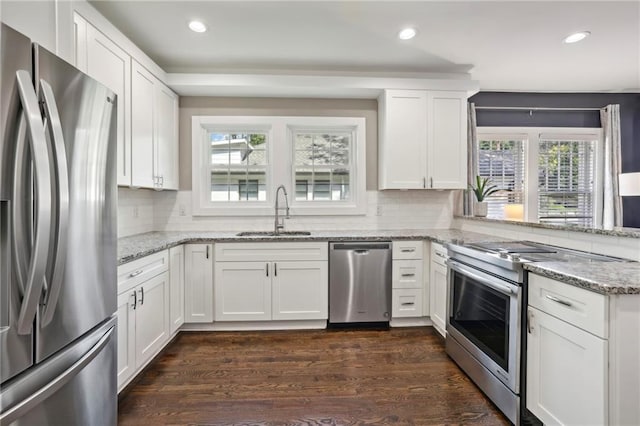 kitchen with sink, stainless steel appliances, and white cabinets