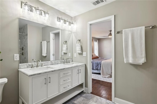 bathroom with ceiling fan, a shower, and vanity