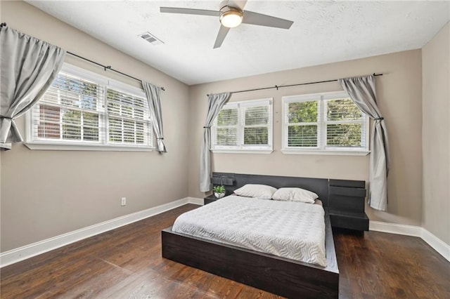 bedroom featuring dark hardwood / wood-style flooring and ceiling fan