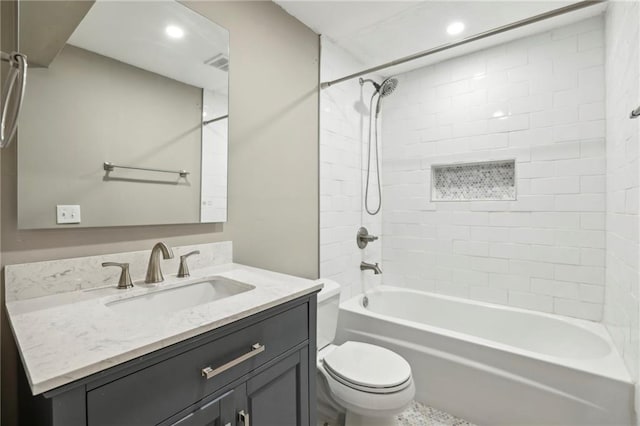 full bathroom with toilet, vanity, and tiled shower / bath