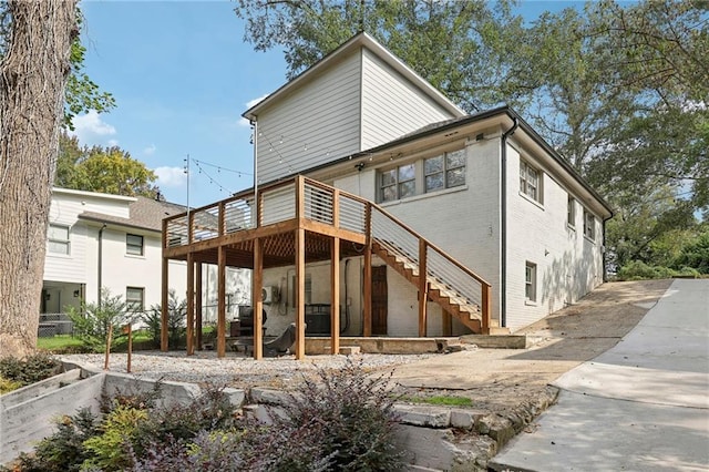 back of house featuring a wooden deck