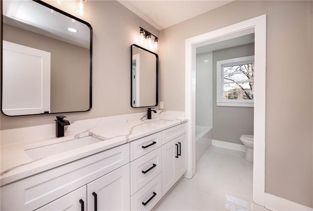 bathroom with vanity, tile patterned flooring, a bathing tub, and toilet