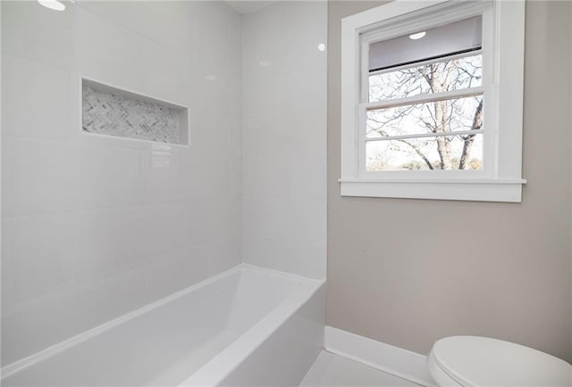 bathroom featuring bathing tub / shower combination and toilet