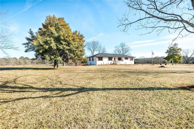 view of front facade with a rural view and a front yard