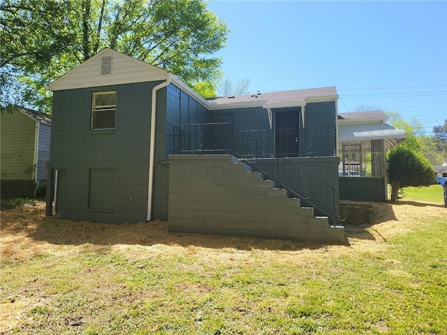 rear view of house with a lawn