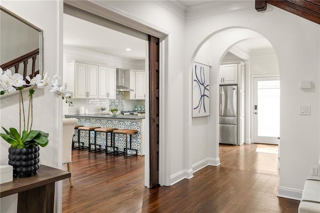 178 Mayson Ave NE, Atlanta, GA 30307 - hallway featuring dark wood-style flooring, arched walkways, baseboards, ornamental molding, and recessed lighting
