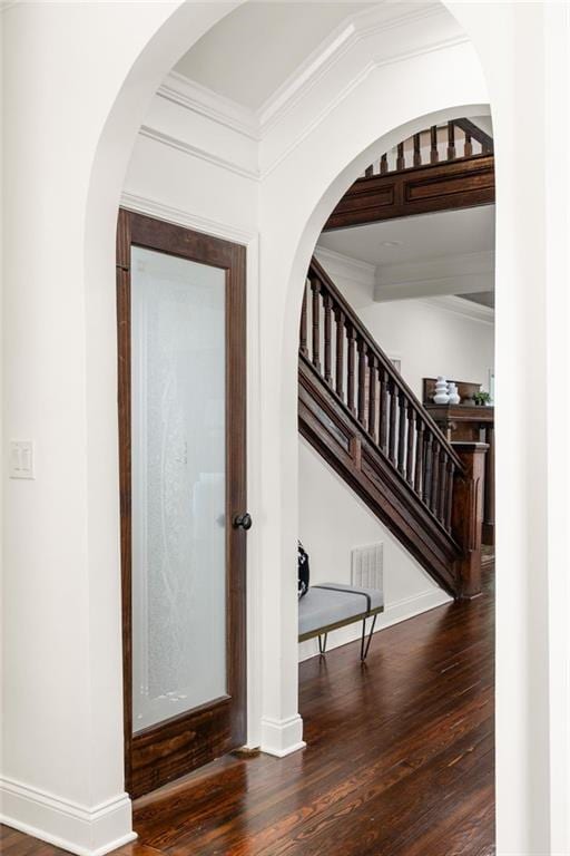 178 Mayson Ave NE, Atlanta, GA 30307 - foyer entrance featuring wood finished floors, ornamental molding, stairway, baseboards, and arched walkways