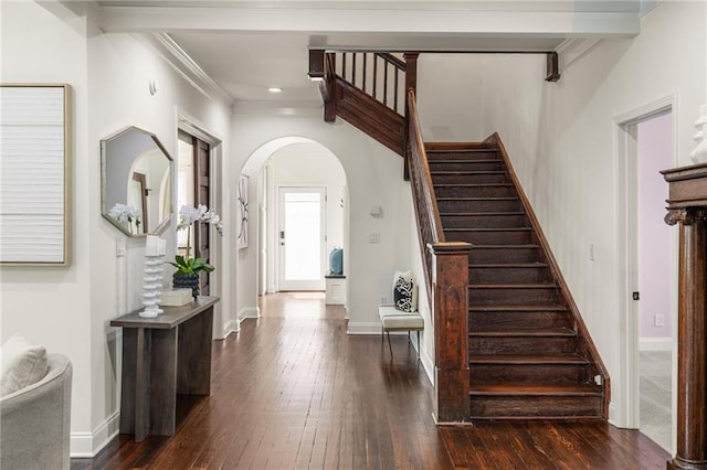 178 Mayson Ave NE, Atlanta, GA 30307 - foyer featuring arched walkways, dark wood-type flooring, stairway, baseboards, and ornamental molding