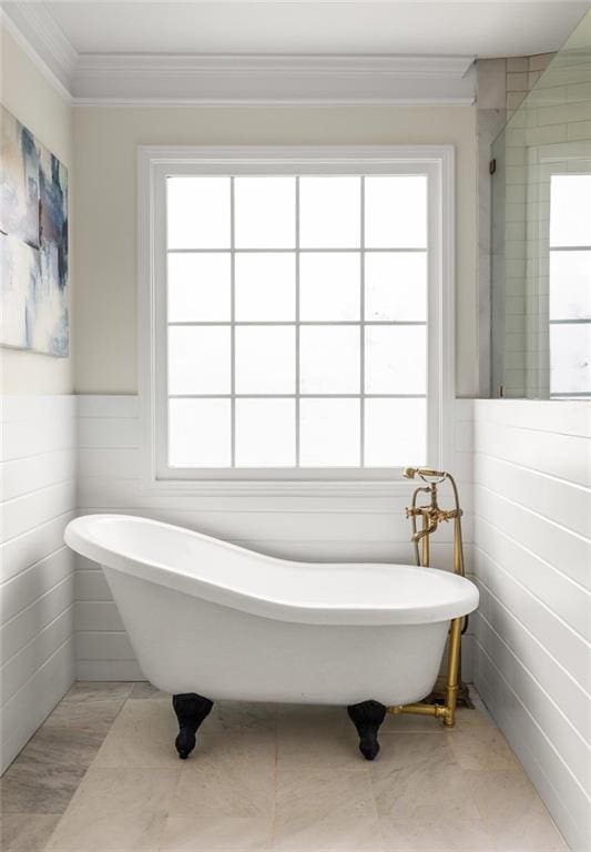 178 Mayson Ave NE, Atlanta, GA 30307 - bathroom featuring a soaking tub, crown molding, tile walls, and a wainscoted wall